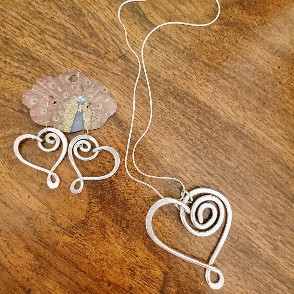 Silver heart necklace with matching earrings.